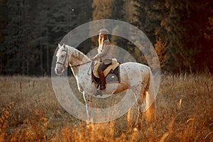 Beautiful young woman in English hunter wear style with Knabstrupper horse