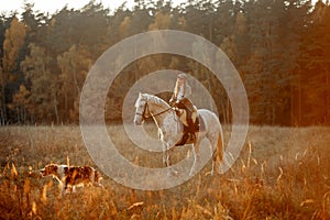 Beautiful young woman in English hunter wear style with Knabstrupper horse