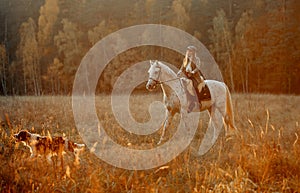 Beautiful young woman in English hunter wear style with Knabstrupper horse