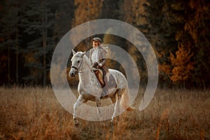 Beautiful young woman in English hunter wear style with Knabstrupper horse