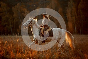 Beautiful young woman in English hunter wear style with Knabstrupper horse