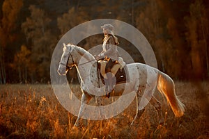 Beautiful young woman in English hunter wear style with Knabstrupper horse