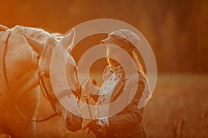 Beautiful young woman in English hunter wear style with Knabstrupper horse