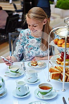 Beautiful young woman enjoying afternoon tea