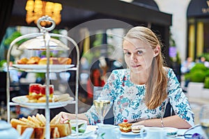 Beautiful young woman enjoying afternoon tea