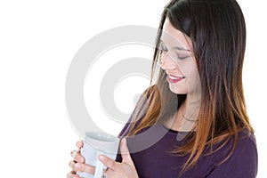 Beautiful young woman enjoying looking cup of coffee