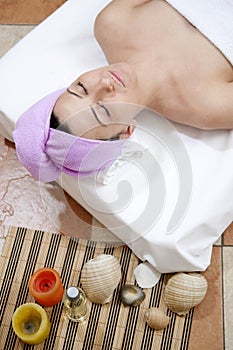 Beautiful young woman enjoying spa salon