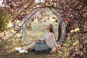 Woman Outdoors in Park Near Spring Blossom Tree