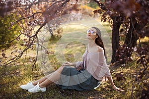 Woman Outdoors in Park Near Spring Blossom Tree