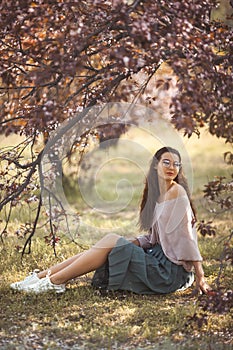 Woman Outdoors in Park Near Spring Blossom Tree