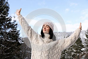 Beautiful young woman enjoying vacation on winter day