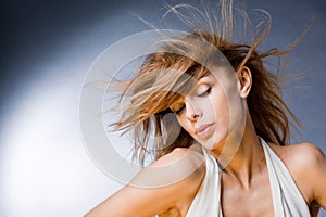 Beautiful young woman enjoying the wind