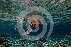 beautiful young woman enjoys snorkeling in the indian ocean. active holiday in the Maldives.