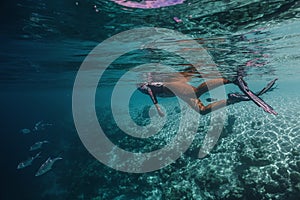 beautiful young woman enjoys snorkeling in the indian ocean. active holiday in the Maldives.