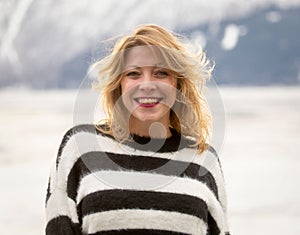 Beautiful young woman enjoys the Winter landscape on the Turnagain Arm, Alaska