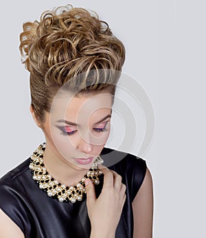 Beautiful young woman with evening make-up and salon hairdo . Smoky eyes. Complicated hairstyle for party