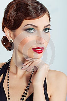 Beautiful young woman with evening makeup and hair, with red lipstick