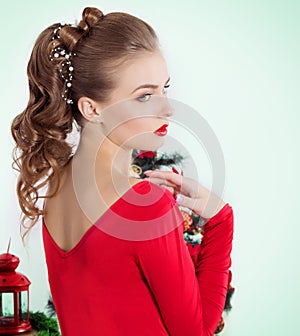 Beautiful young woman with evening makeup and hair, with red lipstick
