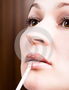 Beautiful young woman eyelash extension. Woman eye with long eyelashes. Beauty salon concept, lipstick lip gloss