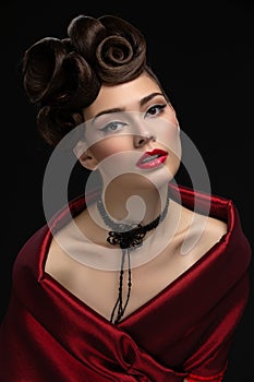 Beautiful young woman with fancy hairdo and red lips