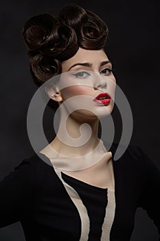 Beautiful young woman with fancy hairdo and red lips