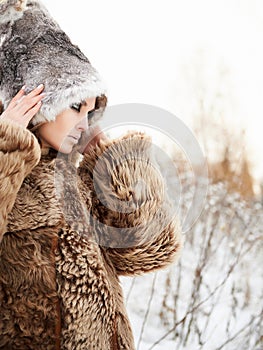 Beautiful young Woman in fashionable Fur Coat and hat