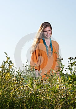 Beautiful young woman in a field. Summer dress