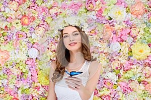 beautiful young woman in floral wreath with butterfly photo