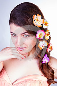 Beautiful young woman with flowers in hair