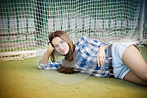 Beautiful young woman on the football field