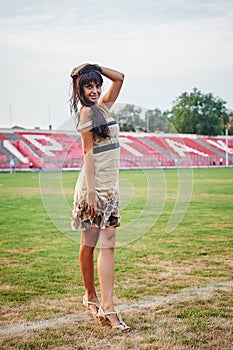 Beautiful young woman on the football field