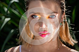 Beautiful young  woman with fresh clean perfect skin and professional make up and flash light on face