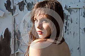 Beautiful Young Woman in Front of Peeling Paint
