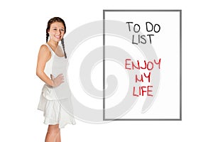 Beautiful young woman in front of a whiteboard with a to-do list