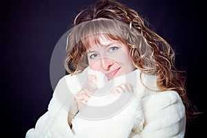 Beautiful young woman in a fur coat