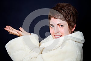 Beautiful young woman in a fur coat