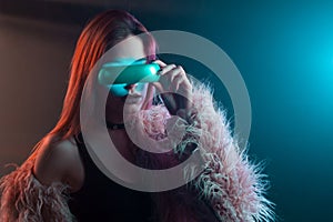 Beautiful young woman in futuristic glasses virtual reality, cyberpunk style, neon light