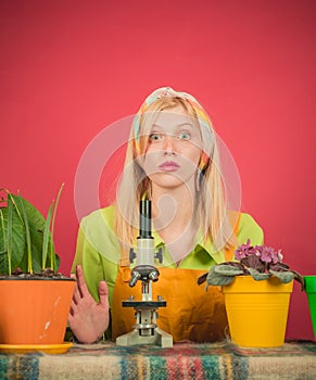 Beautiful young woman gardening. Watering flowers. Woman planting flowers in pot. Cute blonde gardening at isolated