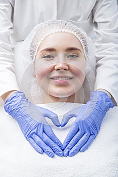 Beautiful young woman getting treatment at beauty salon photo