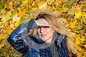 Beautiful young woman girl happy mother playing with her daughter smiling and holding a yellow maple leaves walking in autumn park