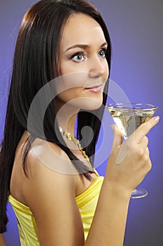 Beautiful young woman with a glass of Martini