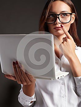 Beautiful young woman in glasses. Student girl with laptop. Business lady