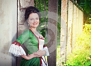 Beautiful young woman in green medieval dress