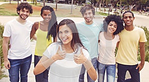 Beautiful young woman with group of friends in retro look