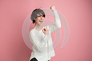 Beautiful young woman happy and excited expressing winning gesture. Successful and celebrating victory, triumphant