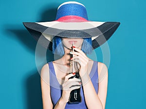 Beautiful young Woman in Hat drink soda