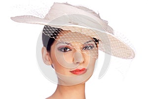 Beautiful young woman with hat and veil