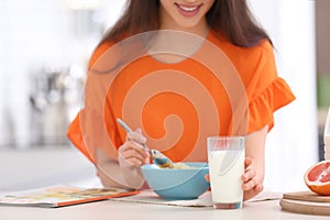 Beautiful young woman having breakfast