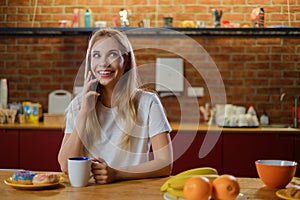 Beautiful young woman having breakfast