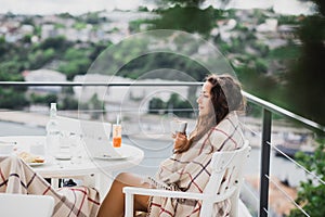 Beautiful young woman having breakfast in a cafe